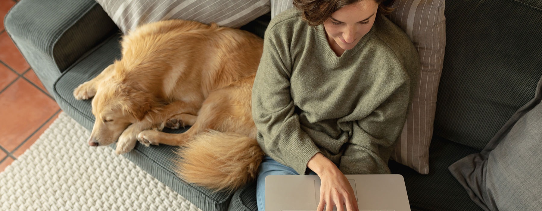 a person and a dog sitting on a couch